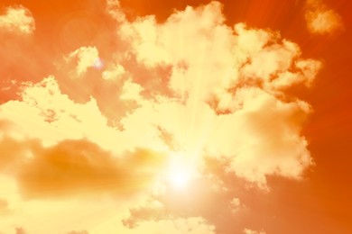 Image of Orange sky with clouds during hot summer weather