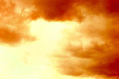 Image of Orange sky with clouds during hot summer weather