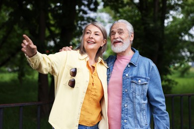 Photo of Lovely senior couple walking together in park