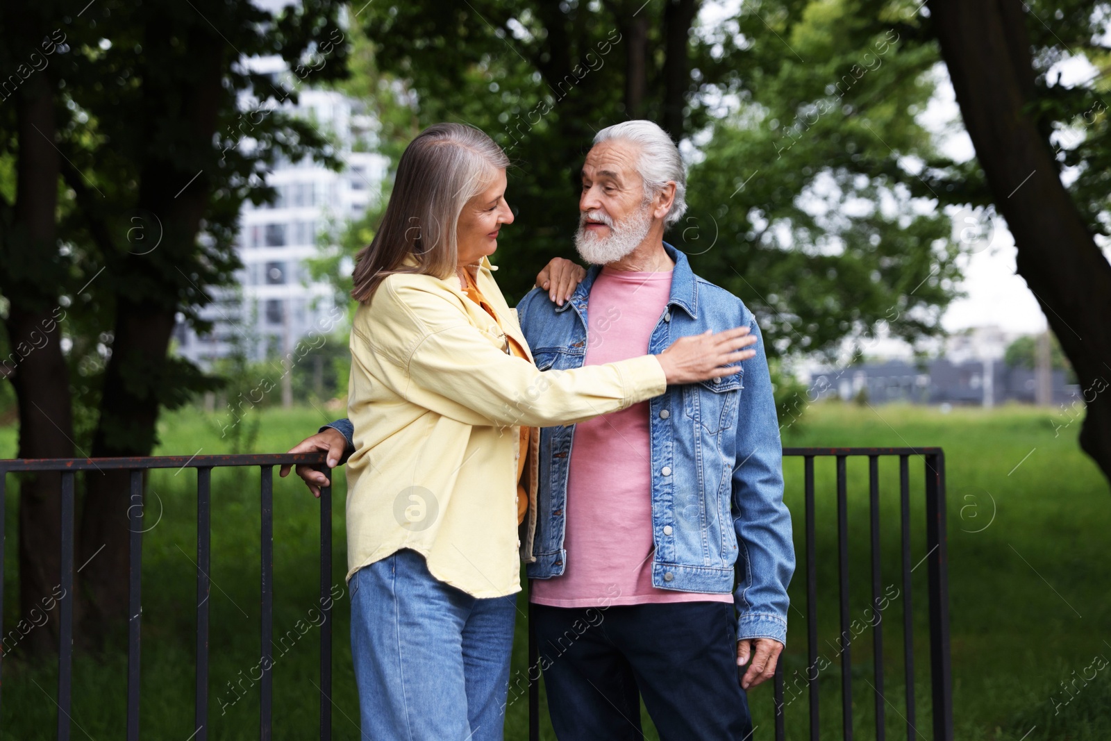 Lovely senior couple walking together in park Photo of Lovely senior couple walking together in park