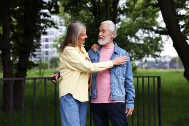 Photo of Lovely senior couple walking together in park