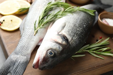 Photo of Fresh raw seabass with spices on table, closeup. Fish and seafood delicacies