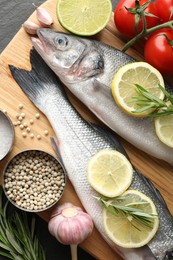 Photo of Fresh raw seabass with spices on table, closeup. Fish and seafood delicacies