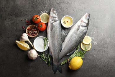 Photo of Fresh raw seabass with spices on grey table, flat lay. Fish and seafood delicacies