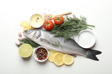 Photo of Fresh raw seabass with spices on white table, flat lay. Fish and seafood delicacies