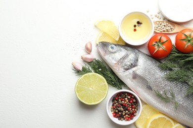Photo of Fresh raw seabass fish with spices on white table, flat lay and space for text. Seafood delicacies