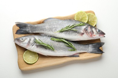 Photo of Fresh raw seabass with spices on white table, top view. Fish and seafood delicacies