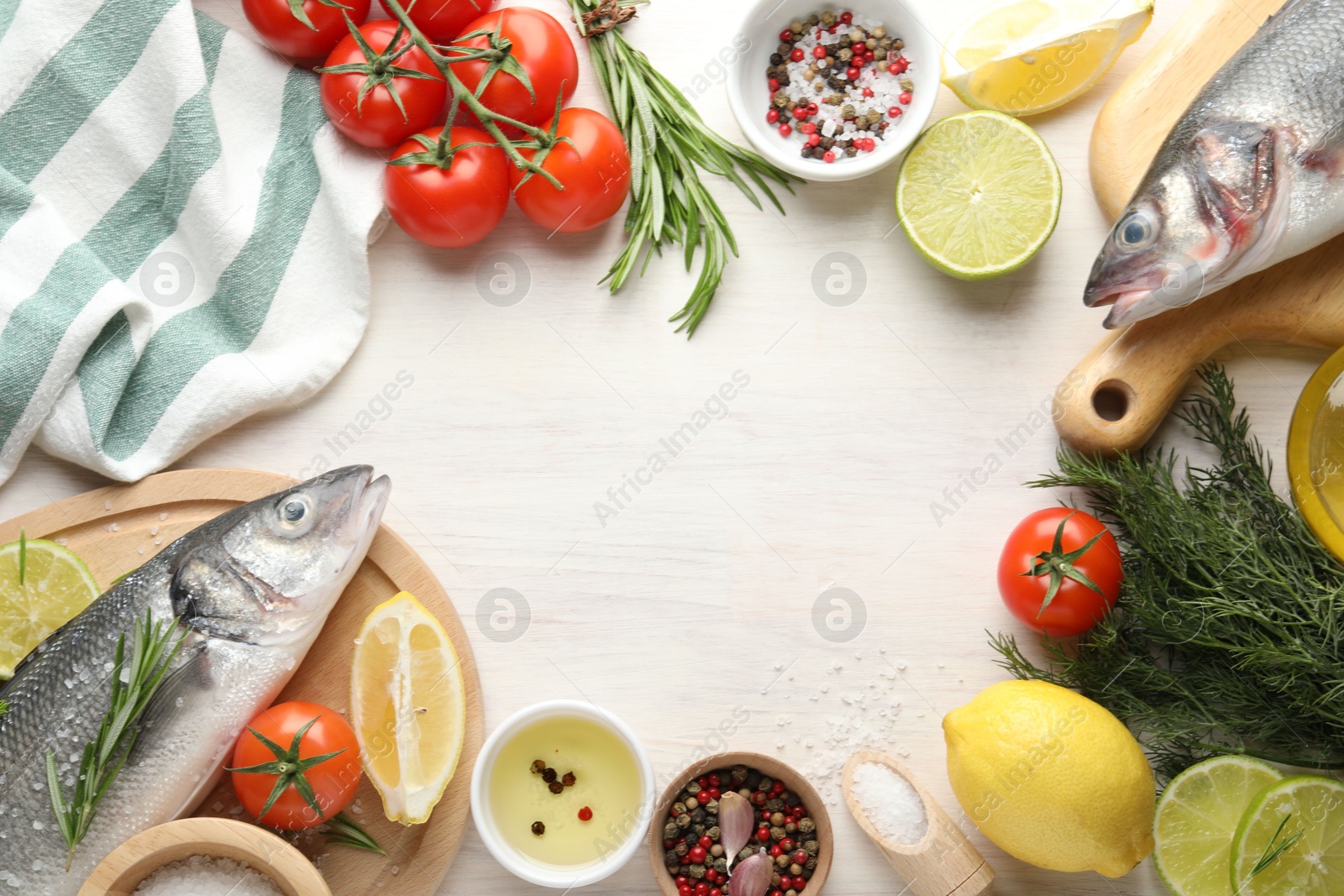 Frame of fresh raw seabass fish with spices on white wooden table, flat lay and space for text. Seafood delicacies Photo of Frame of fresh raw seabass fish with spices on white wooden table, flat lay and space for text. Seafood delicacies