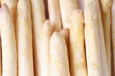 Photo of Raw white asparagus spears as background, closeup