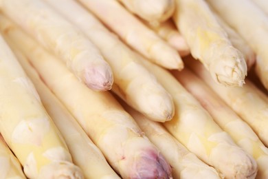 Photo of Raw white asparagus spears as background, closeup