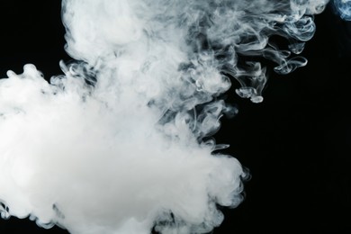 Photo of Beautiful hookah smoke on black background, closeup