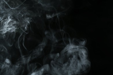 Photo of Hookah smoke on black background, closeup. Space for text