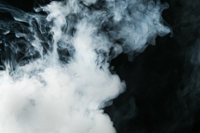 Photo of Beautiful hookah smoke on black background, closeup