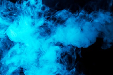 Photo of Hookah smoke in blue light on black background, closeup