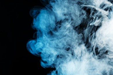 Photo of Beautiful hookah smoke on black background, closeup