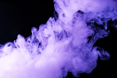 Photo of Hookah smoke in violet light on black background, closeup