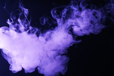 Photo of Hookah smoke in violet light on black background, closeup
