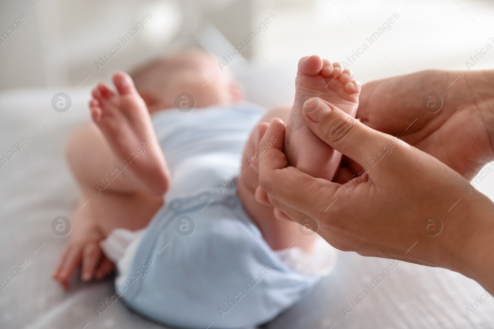 Pediatrician examining baby at table in clinic, closeup Photo of Pediatrician examining baby at table in clinic, closeup