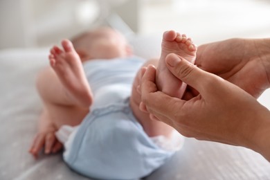 Photo of Pediatrician examining baby at table in clinic, closeup