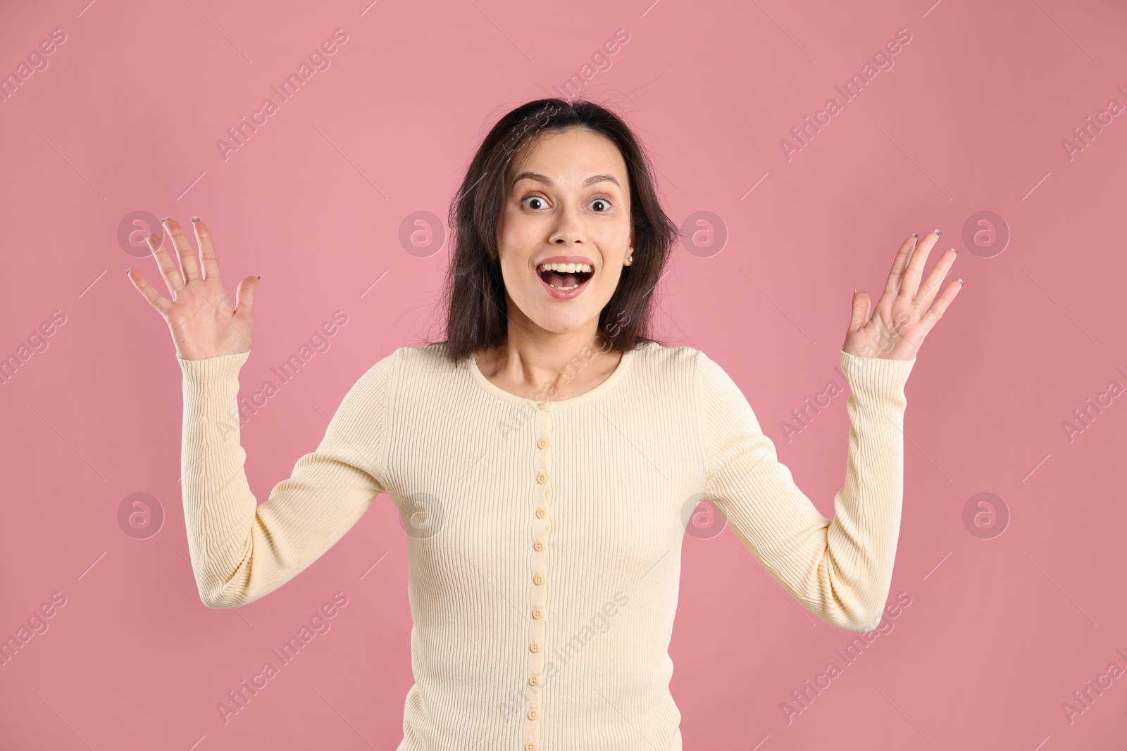 Portrait of surprised woman on pink background Photo of Portrait of surprised woman on pink background