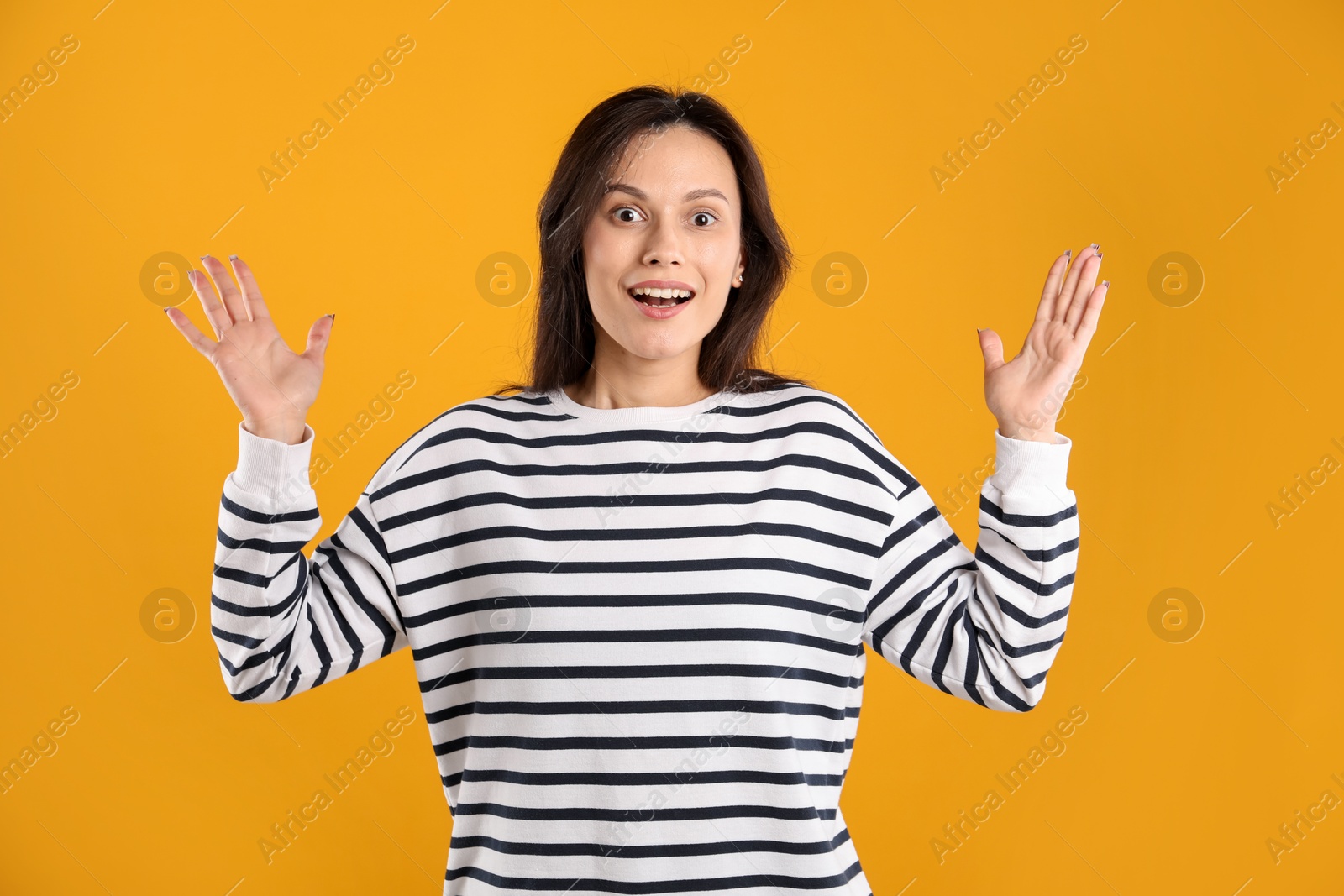 Portrait of surprised woman on orange background Photo of Portrait of surprised woman on orange background