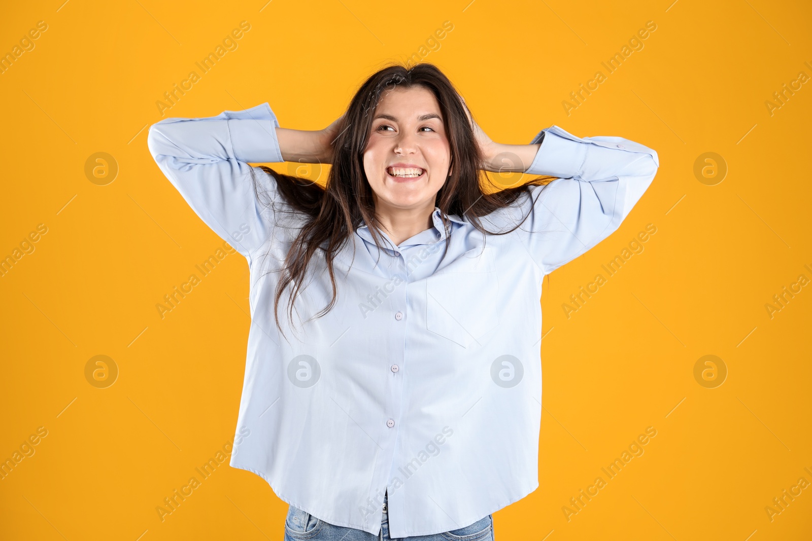 Portrait of surprised woman on orange background Photo of Portrait of surprised woman on orange background