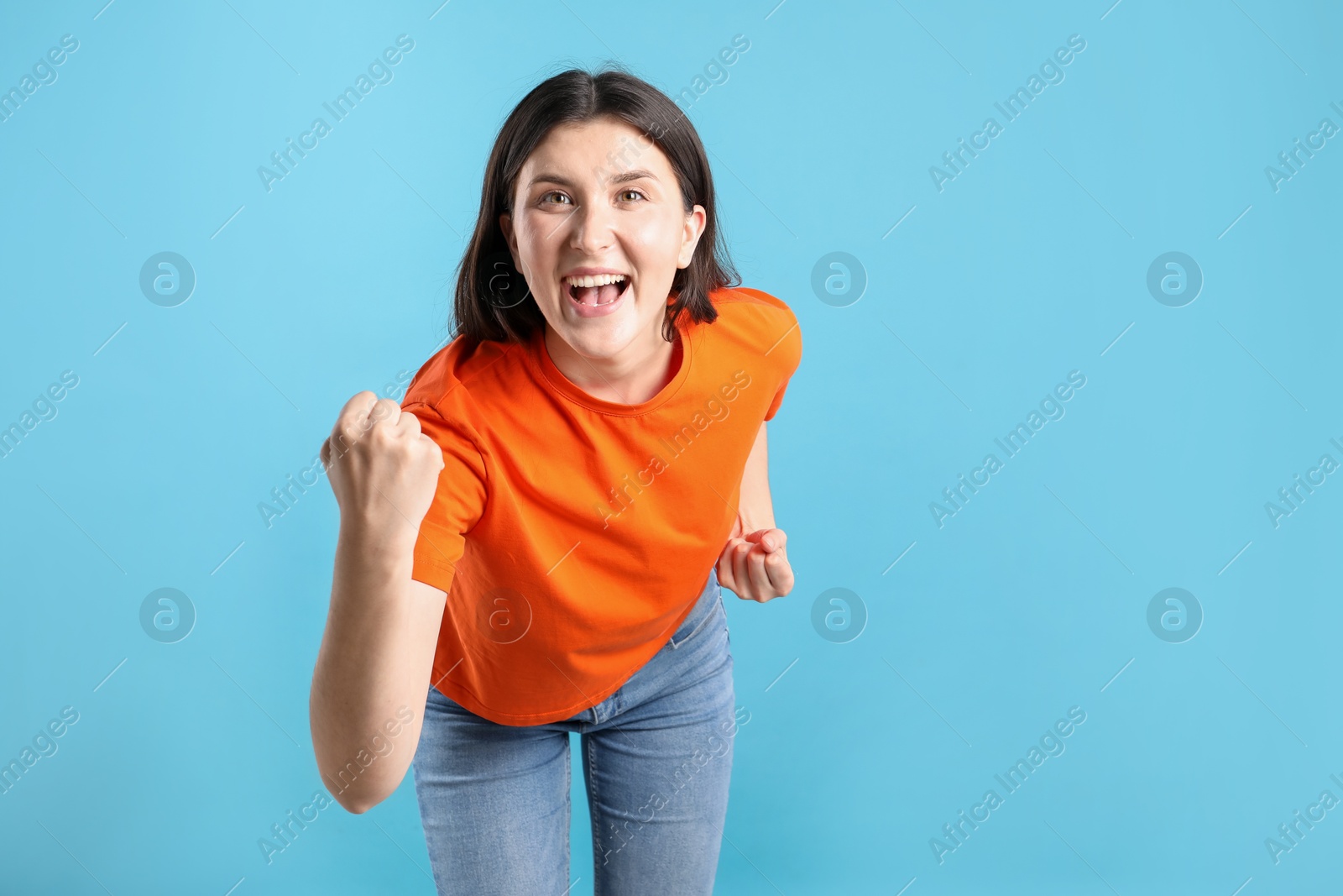 Portrait of emotional woman on light blue background, space for text Photo of Portrait of emotional woman on light blue background, space for text