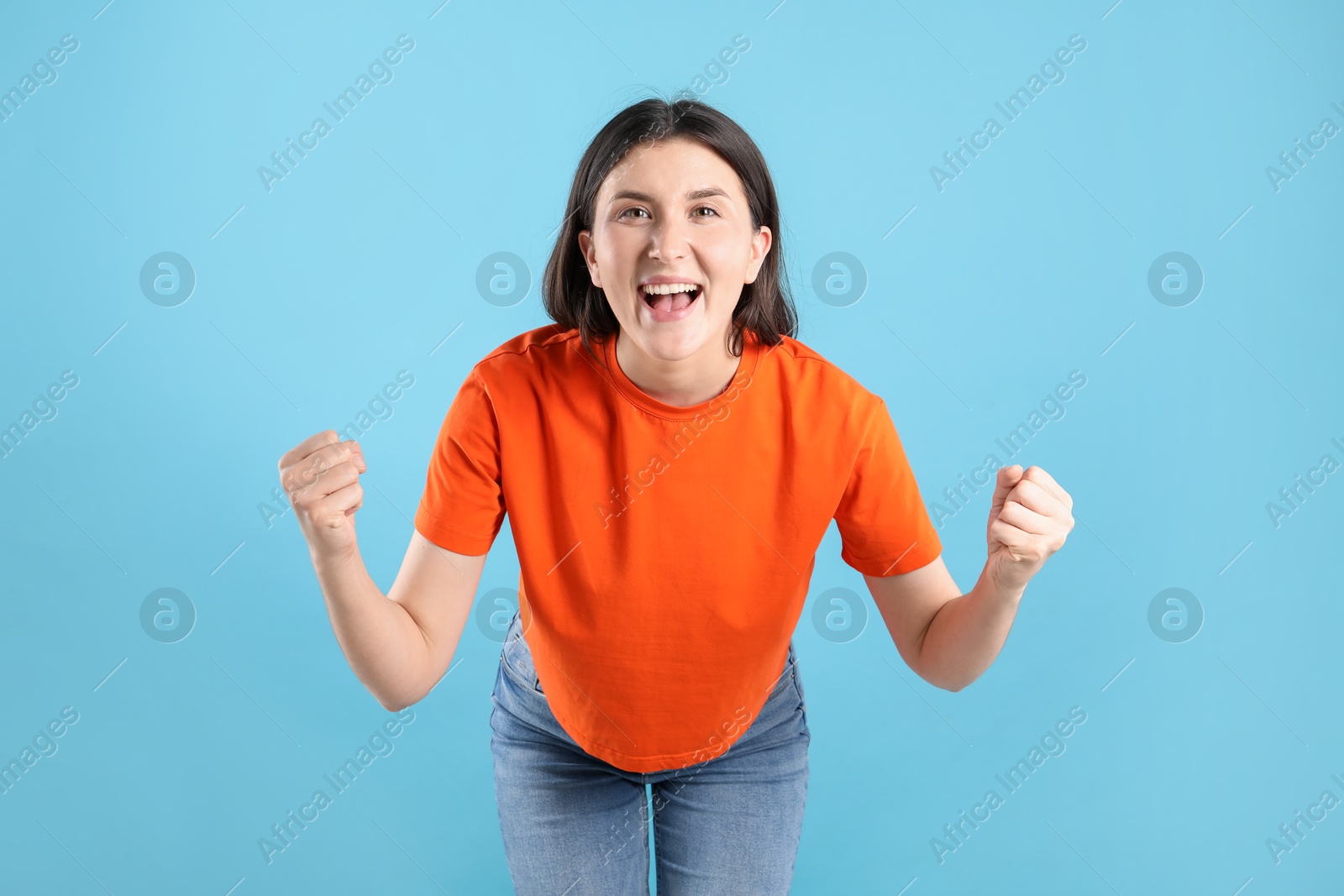 Portrait of emotional woman on light blue background Photo of Portrait of emotional woman on light blue background