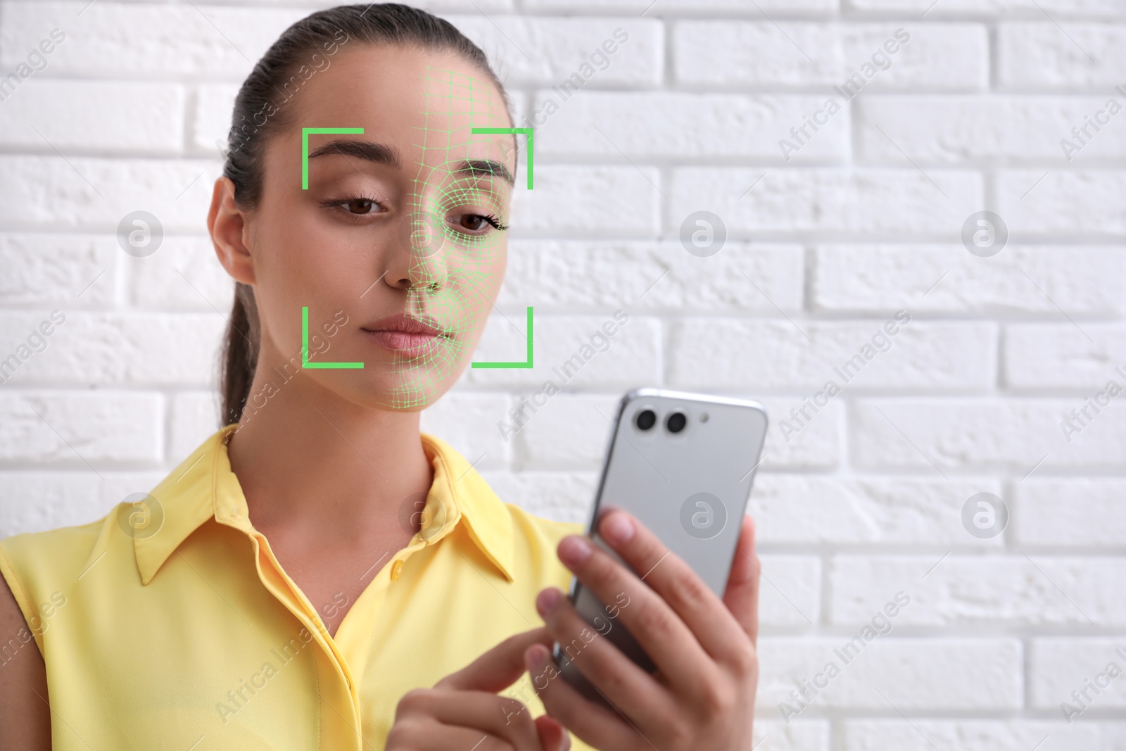 Woman unlocking her smartphone with facial recognition app indoors. Biometric verification Image of Woman unlocking her smartphone with facial recognition app indoors. Biometric verification