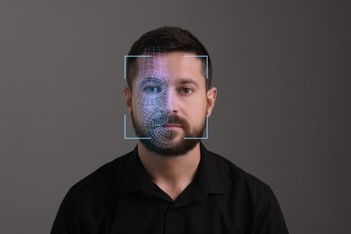 Image of Facial recognition system. Scanning man's face for authentication against grey background