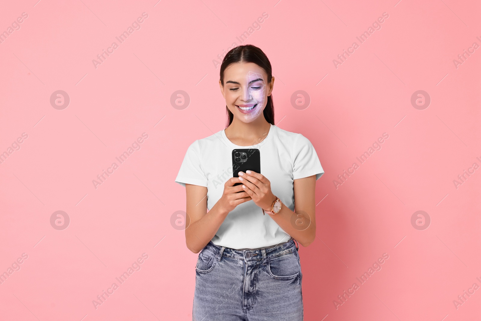 Woman unlocking her smartphone with facial scanner against pink background. Biometric verification Image of Woman unlocking her smartphone with facial scanner against pink background. Biometric verification