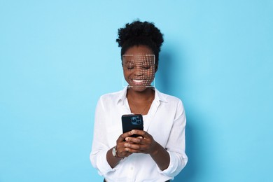 Image of Woman unlocking her smartphone with facial scanner against light blue background. Biometric verification