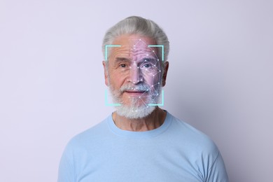 Image of Facial recognition system. Scanning man's face for authentication against white background
