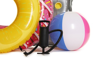 Photo of Inflatable rings, mattress, ball and manual air pump isolated on white