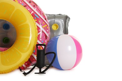 Photo of Inflatable rings, mattress, ball and manual air pump isolated on white