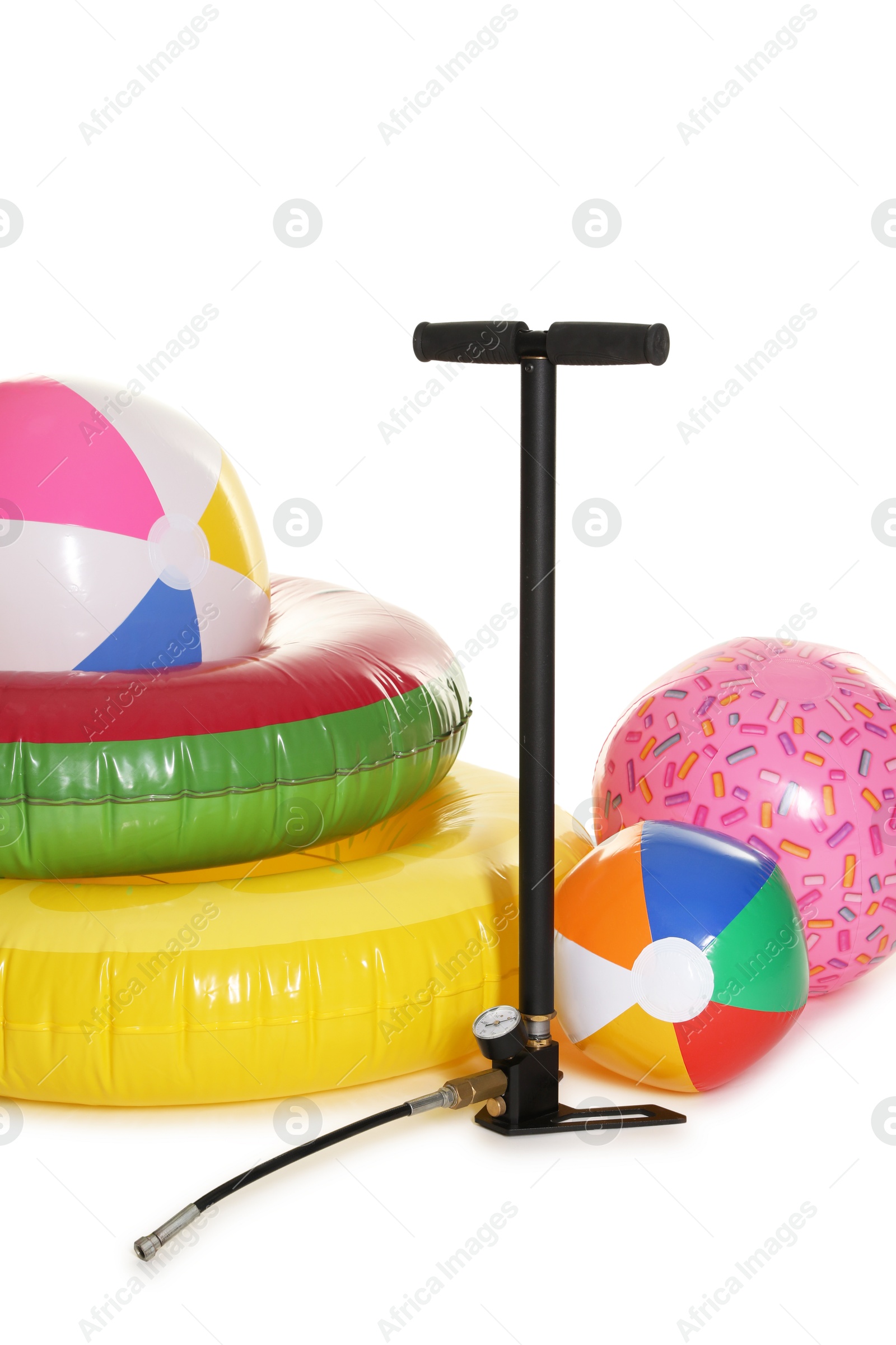 Inflatable rings, balls and manual air pump isolated on white Photo of Inflatable rings, balls and manual air pump isolated on white