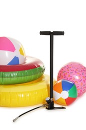 Photo of Inflatable rings, balls and manual air pump isolated on white