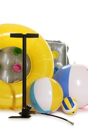 Photo of Inflatable ring, mattress, balls and manual air pump isolated on white