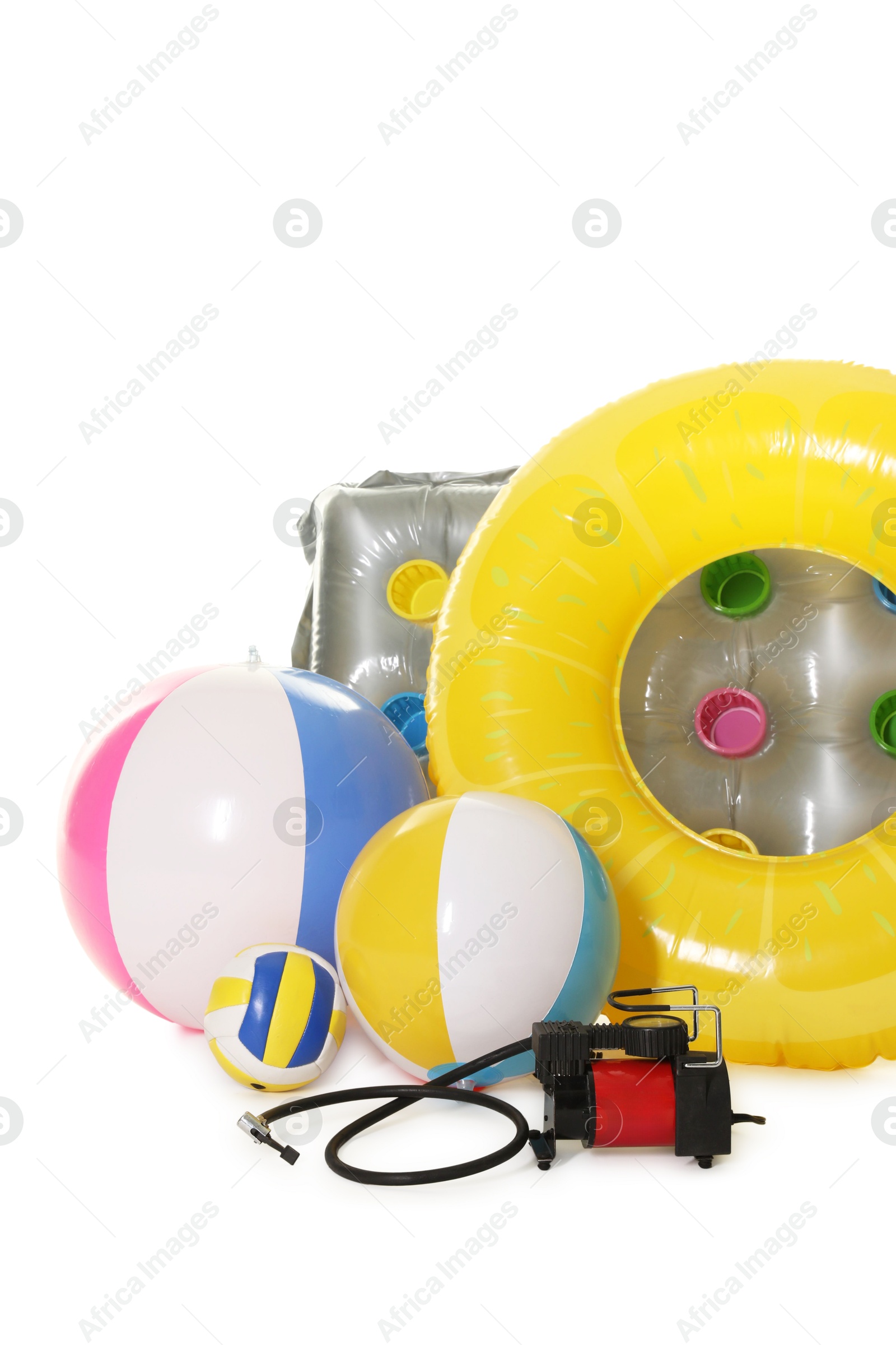 Inflatable ring, mattress, balls and air compressor isolated on white Photo of Inflatable ring, mattress, balls and air compressor isolated on white