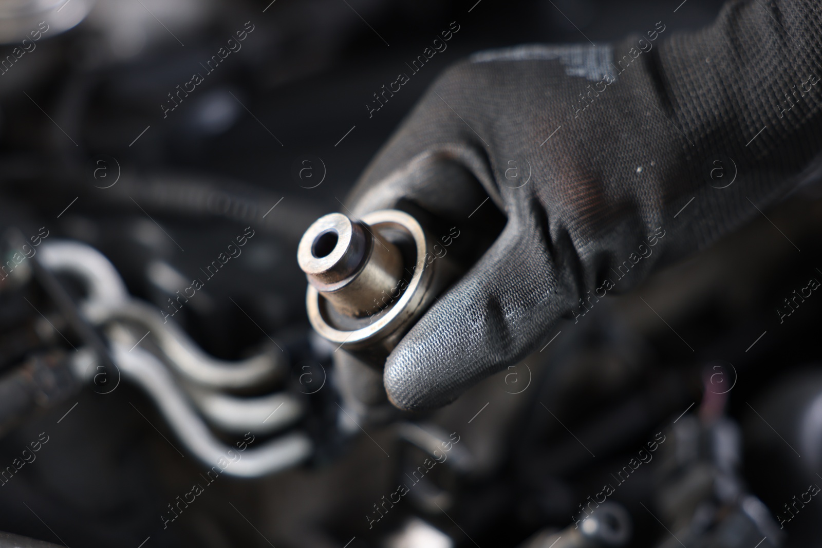 Auto part. Professional mechanic with bearings near open hood of car indoors, closeup. Space for text Photo of Auto part. Professional mechanic with bearings near open hood of car indoors, closeup. Space for text