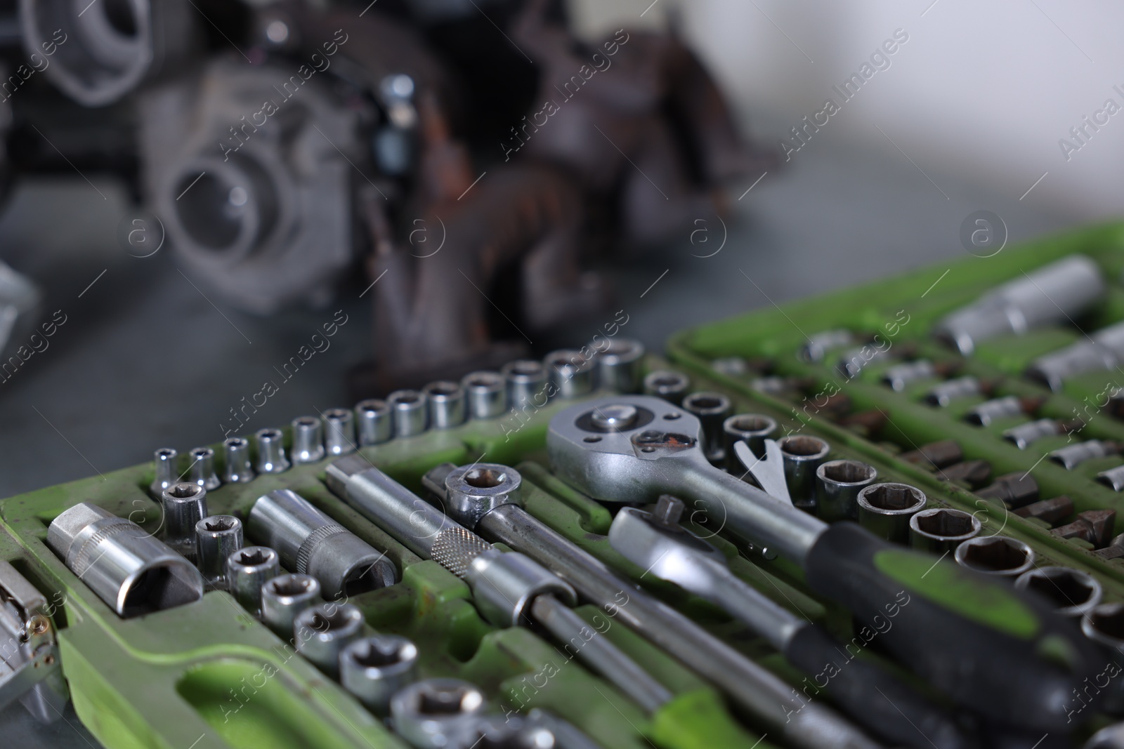 Different auto parts and tools on table indoors, closeup Photo of Different auto parts and tools on table indoors, closeup