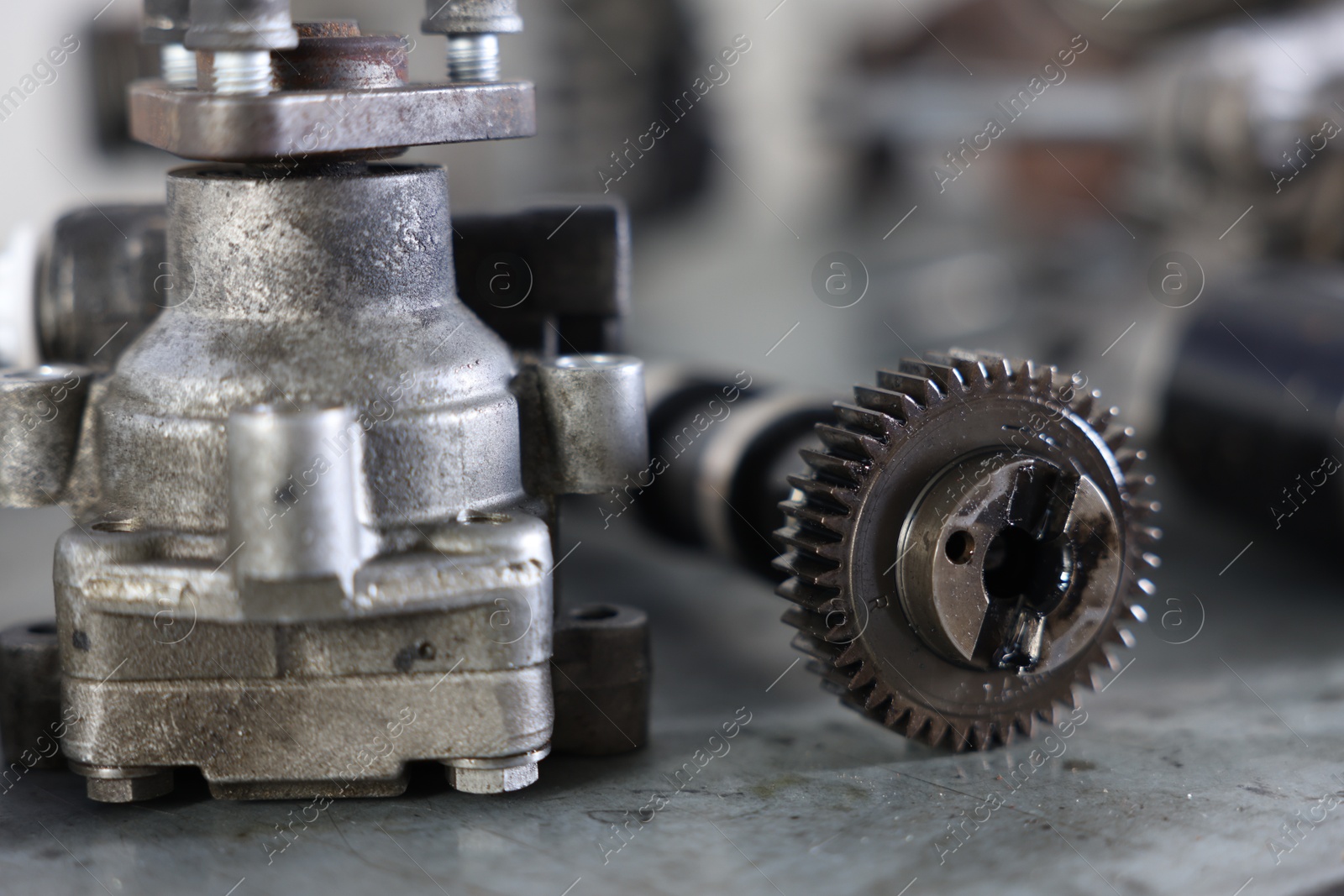 Different auto parts on grey table indoors, closeup Photo of Different auto parts on grey table indoors, closeup
