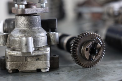 Photo of Different auto parts on grey table indoors, closeup