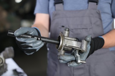 Photo of Auto part. Professional mechanic with manual transmission indoors, closeup