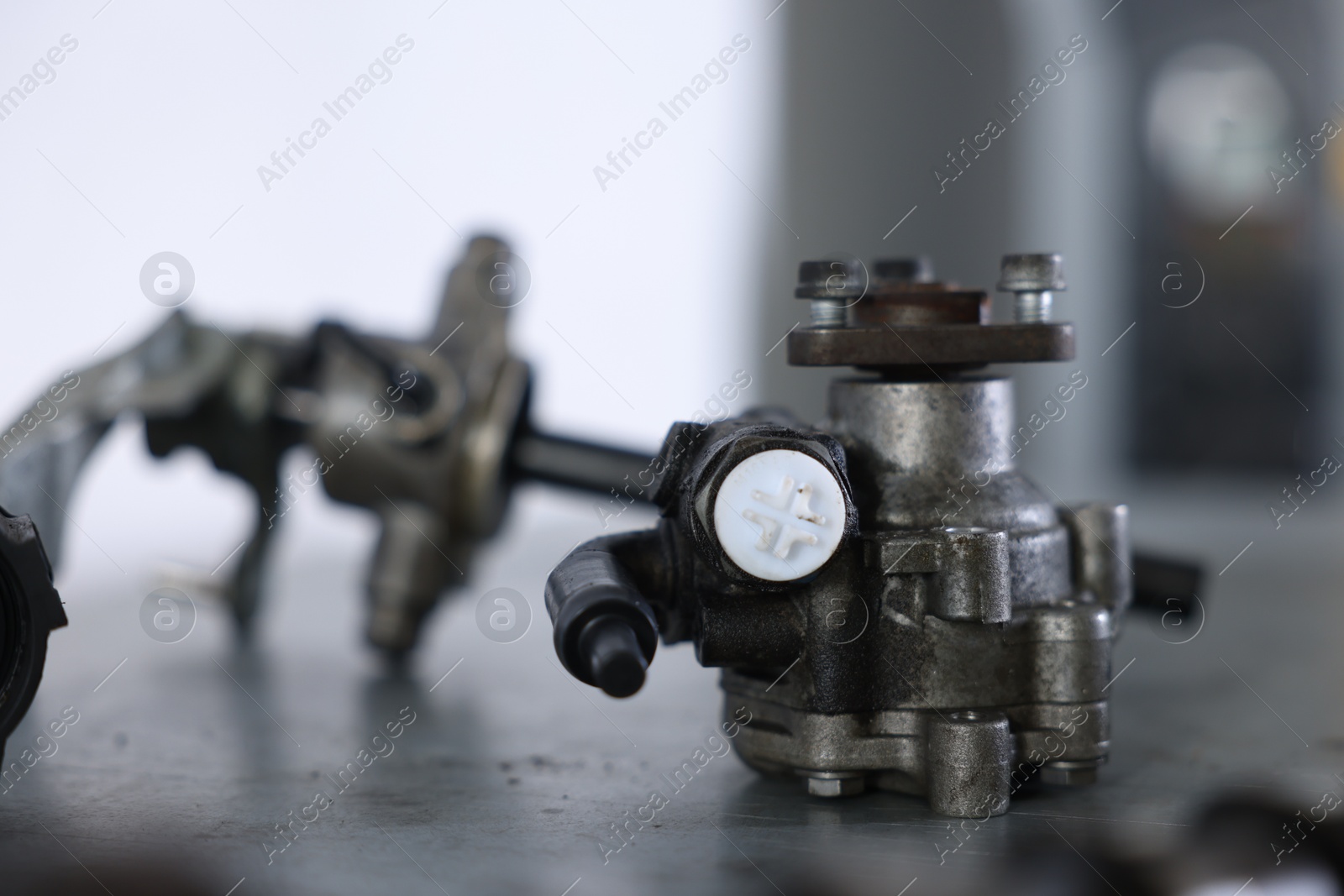 Different auto parts on grey table indoors, closeup Photo of Different auto parts on grey table indoors, closeup