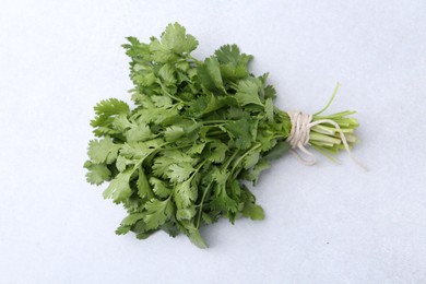 Photo of Bunch of fresh aromatic cilantro on white table, top view