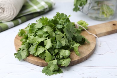 Photo of Fresh aromatic cilantro on white table, closeup