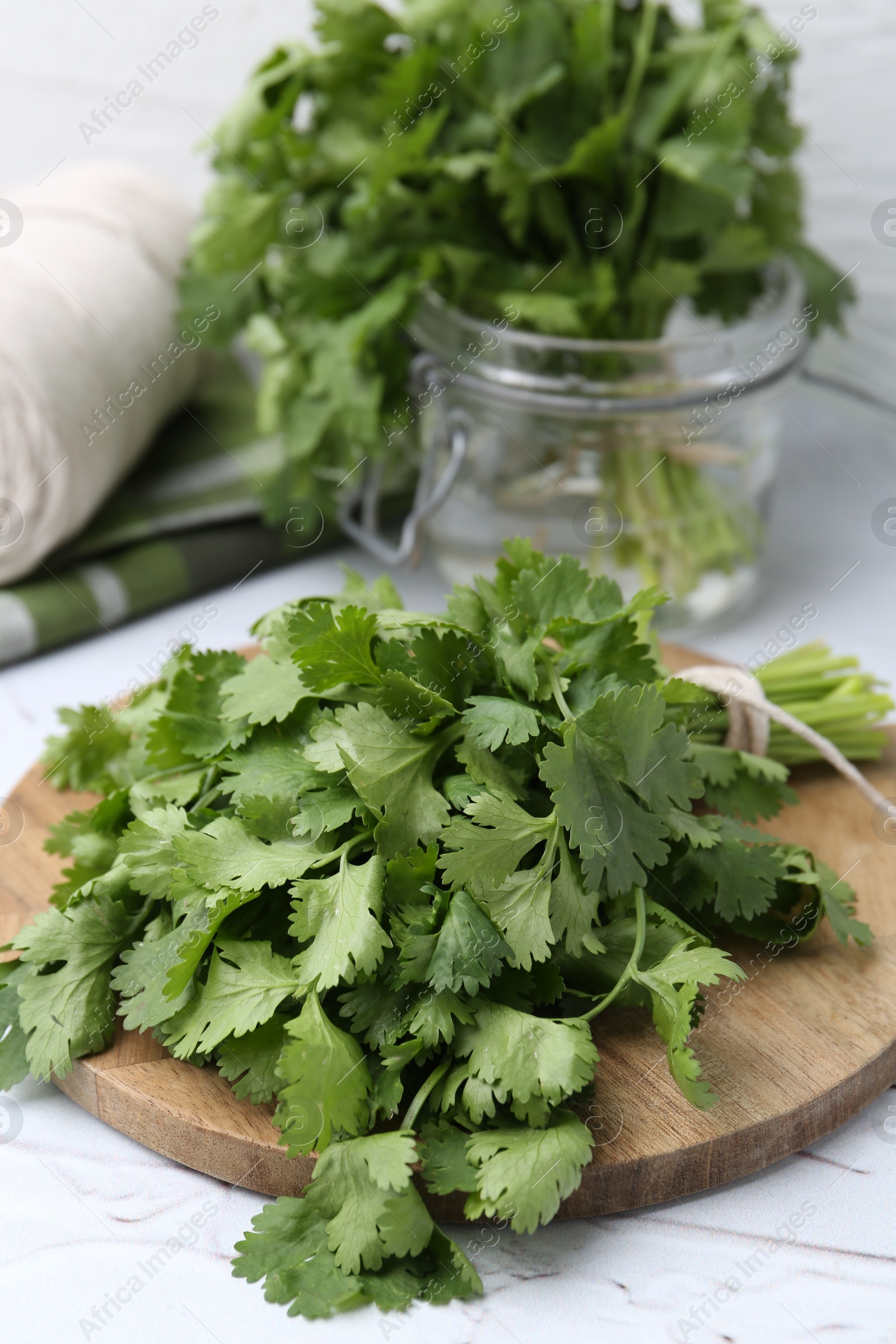 Fresh aromatic cilantro on white table, closeup Photo of Fresh aromatic cilantro on white table, closeup