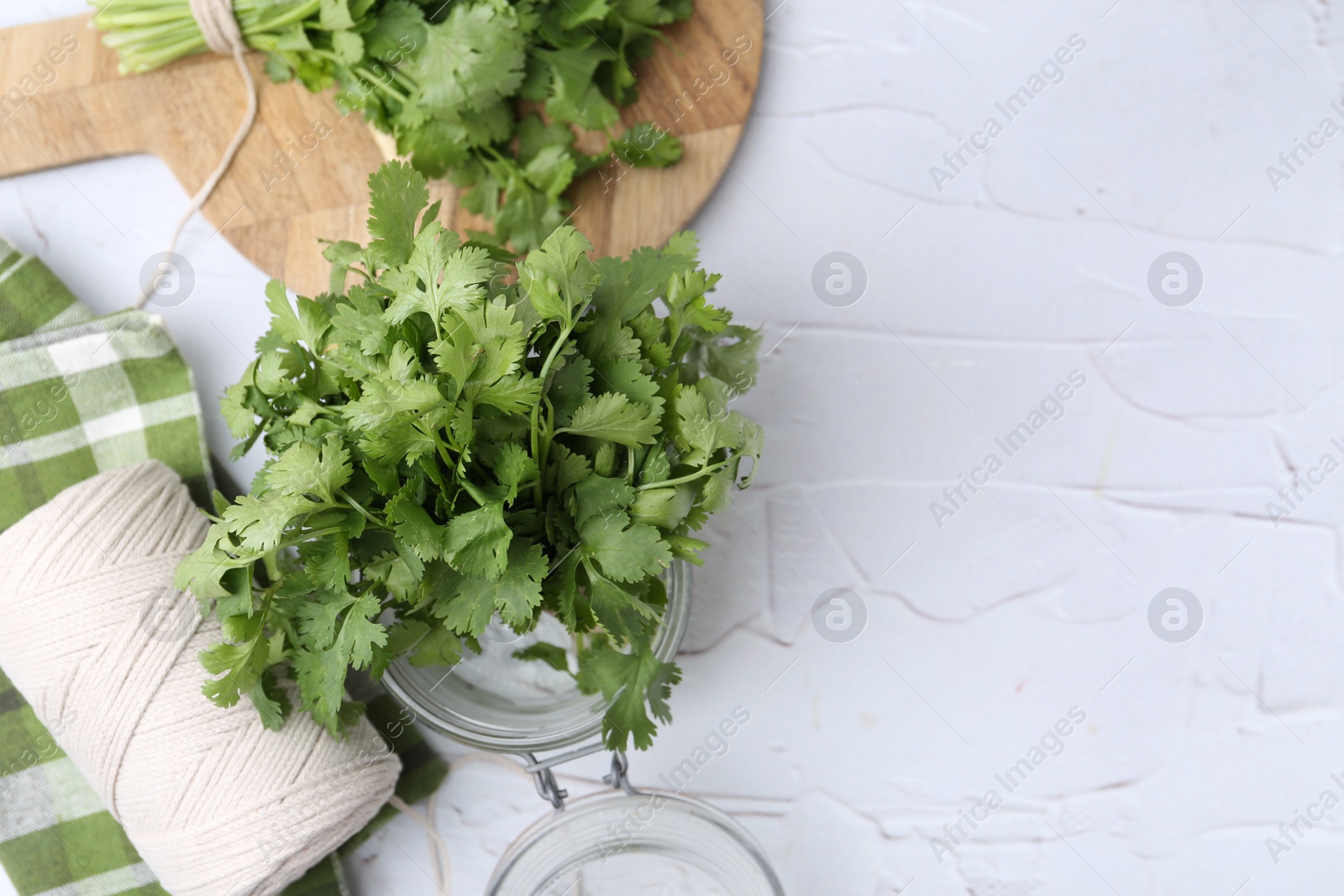 Fresh aromatic cilantro in jar on white table, flat lay. Space for text Photo of Fresh aromatic cilantro in jar on white table, flat lay. Space for text