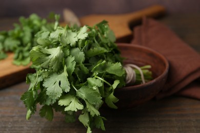Photo of Fresh aromatic cilantro on wooden table, closeup